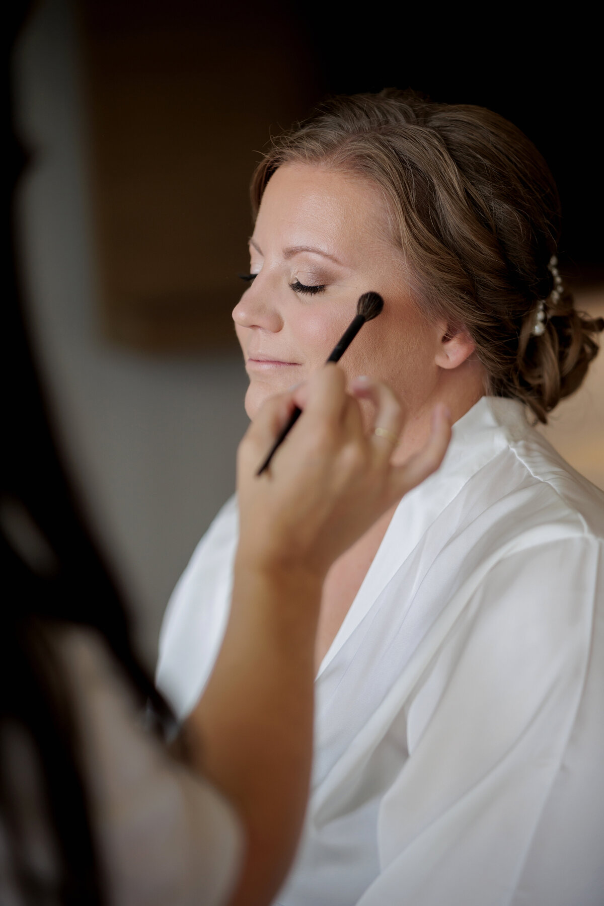 bride getting makeup on