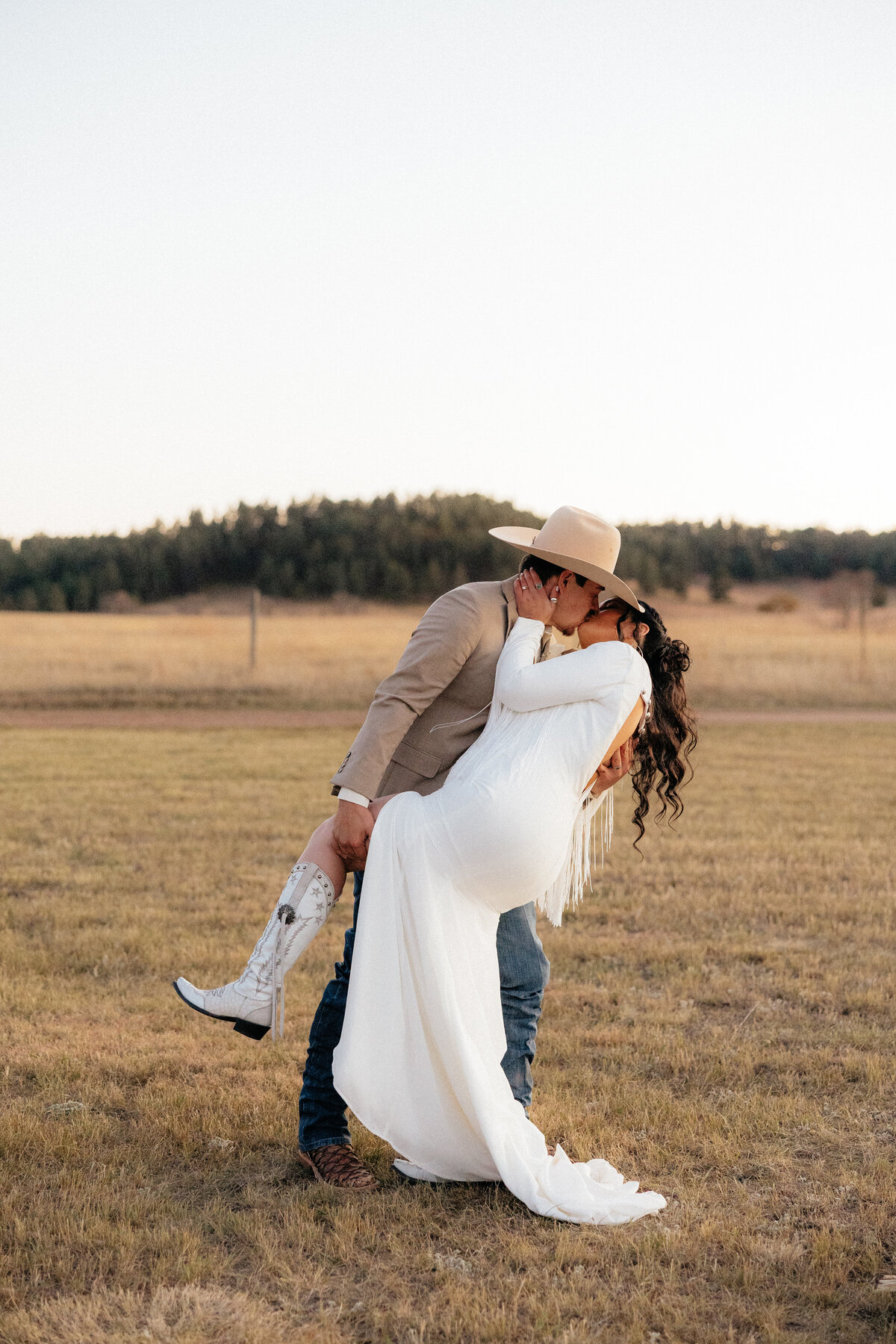 Nick dipping Tiernee at their boho wedding in Hermosa, South Dakota.