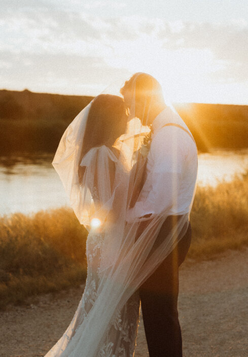 bride-and-groom-touching-noses-during-golden-hour