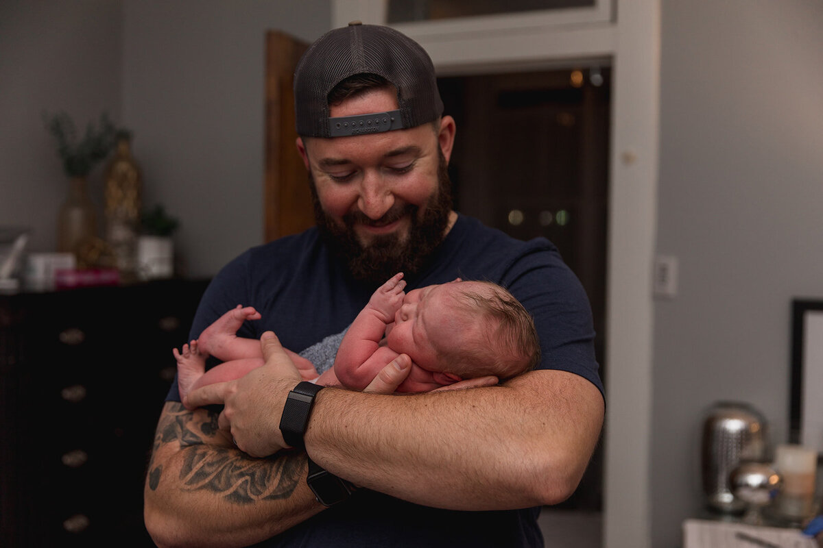 Dad Holds New Baby for First Time