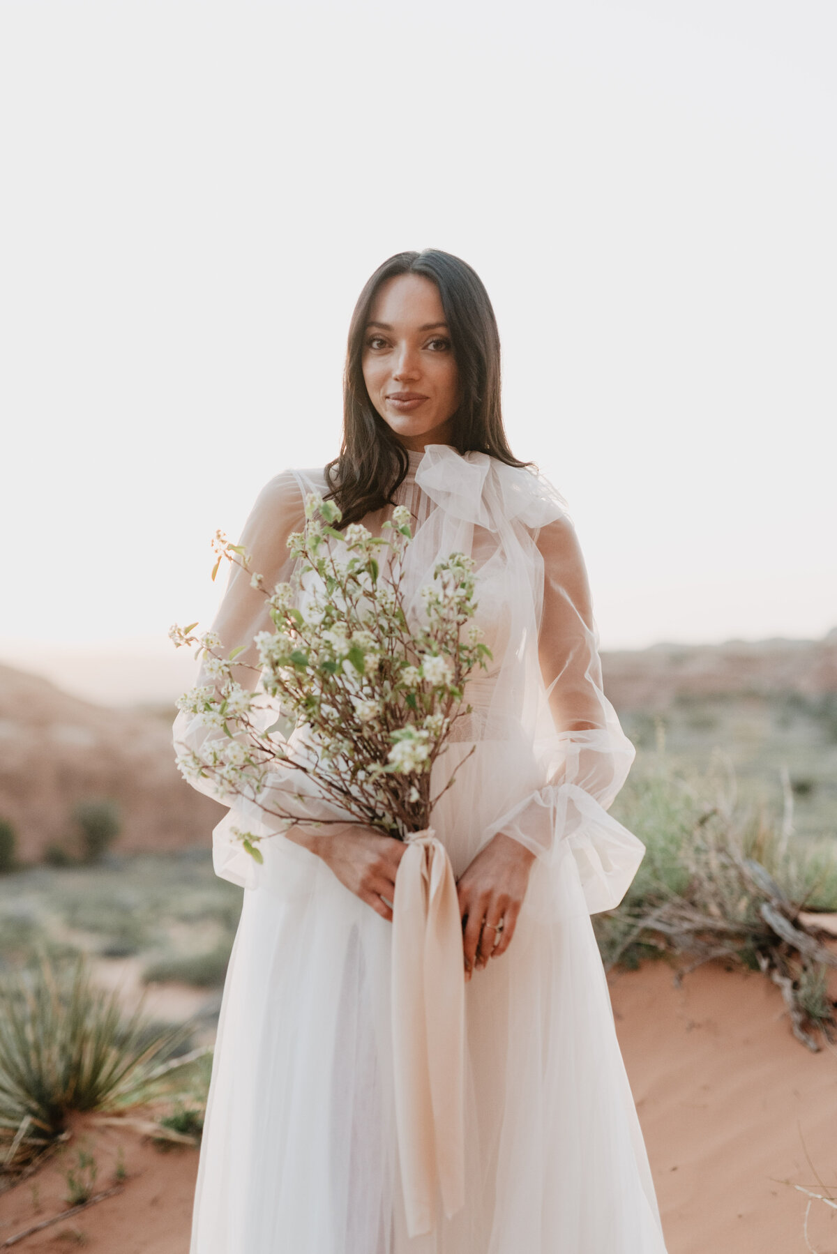 Utah elopement photographer captures bride holding bouquet and smiling