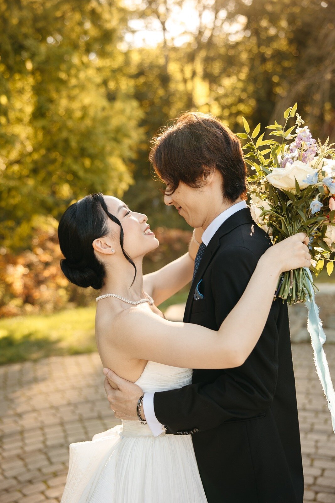 Bride and groom about to hug while happily dancing and facing each other