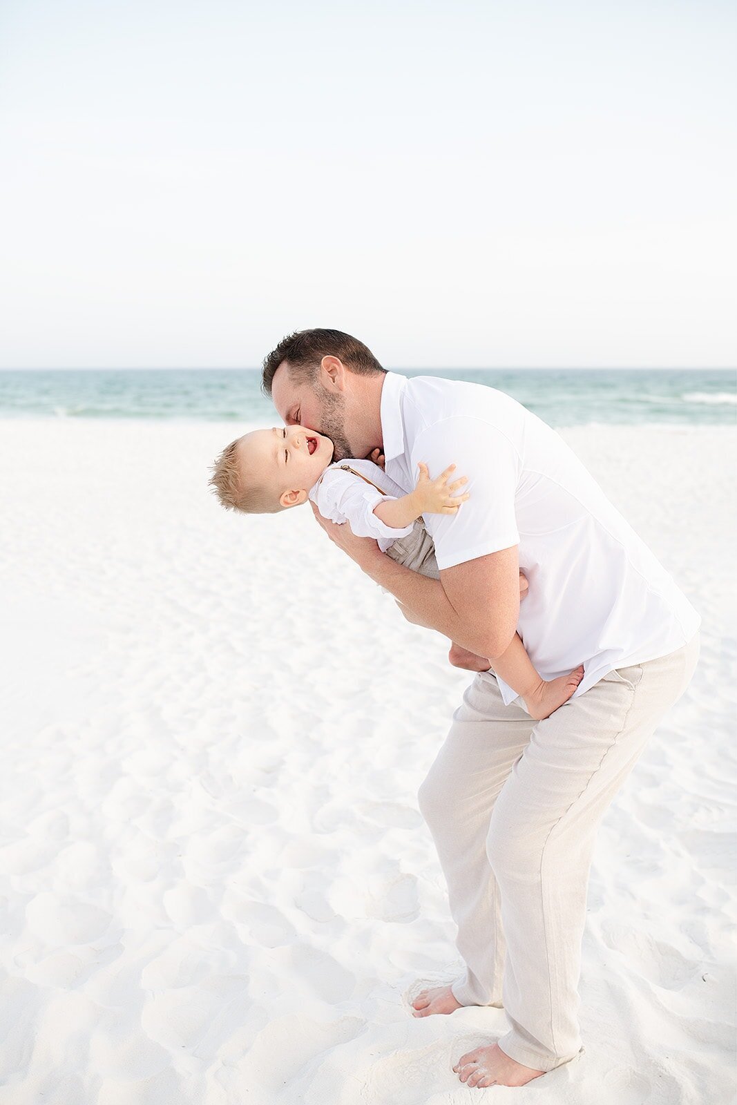 a father and his toddler having fun during destin family photography session