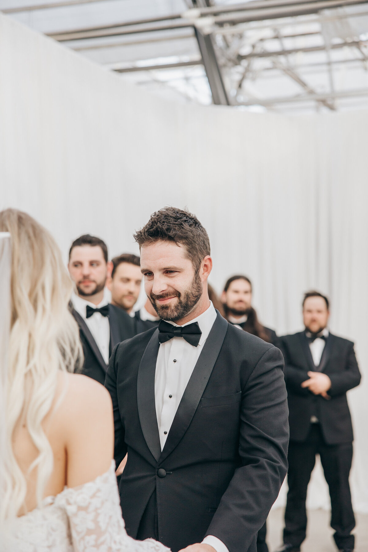 Candid moment of groom smiling photographed by Nova Markina