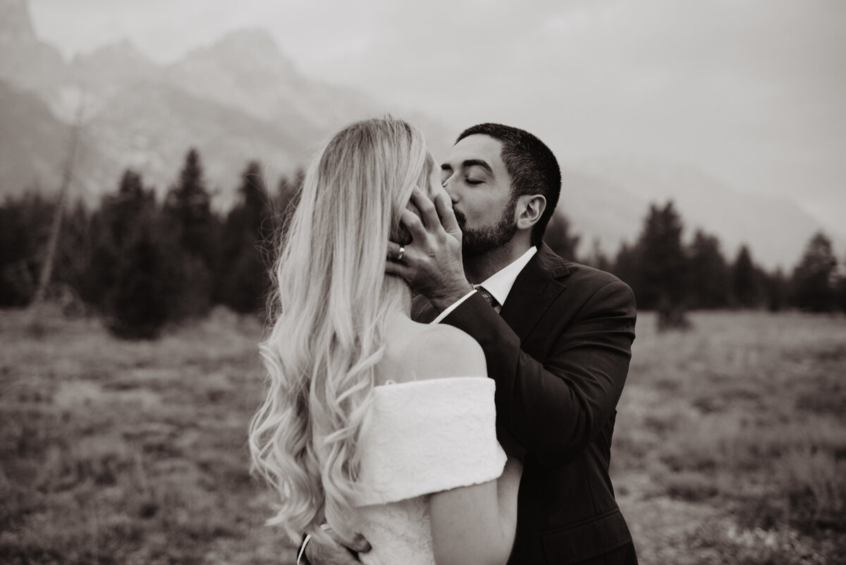Photographers Jackson Hole capture groom kissing bride