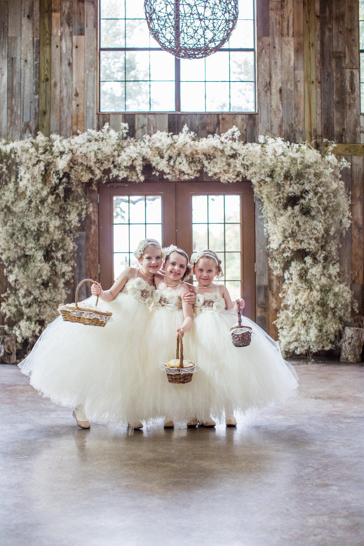 flower girls pose for portrait before wedding ceremony in Texas Hill Country wedding at Vista West Ranch