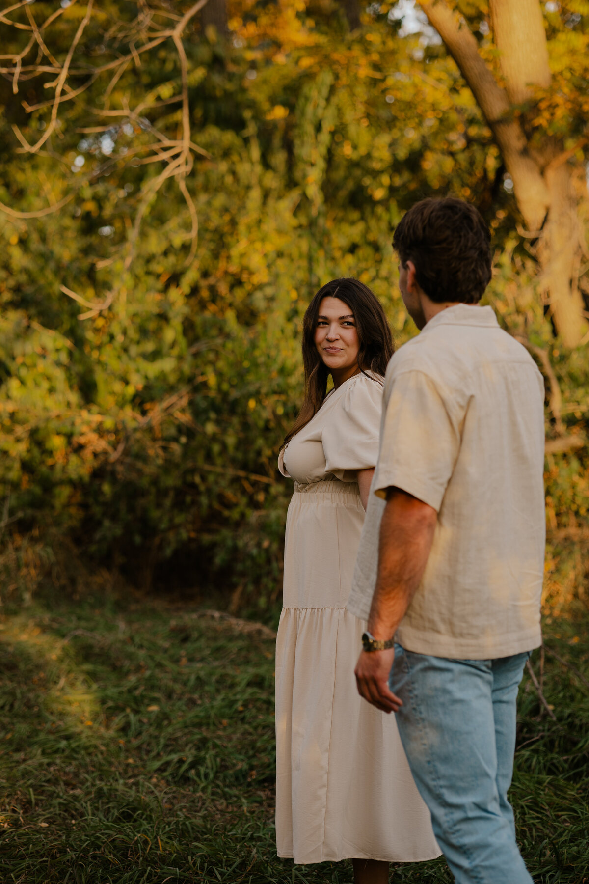 Couple's engagement session in Omaha during golden hour, surrounded by warm fall foliage – captured by Tori Nichole Photography. Authentic, romantic moments in a stunning autumnal setting, reflecting the beauty of the season and their love story.