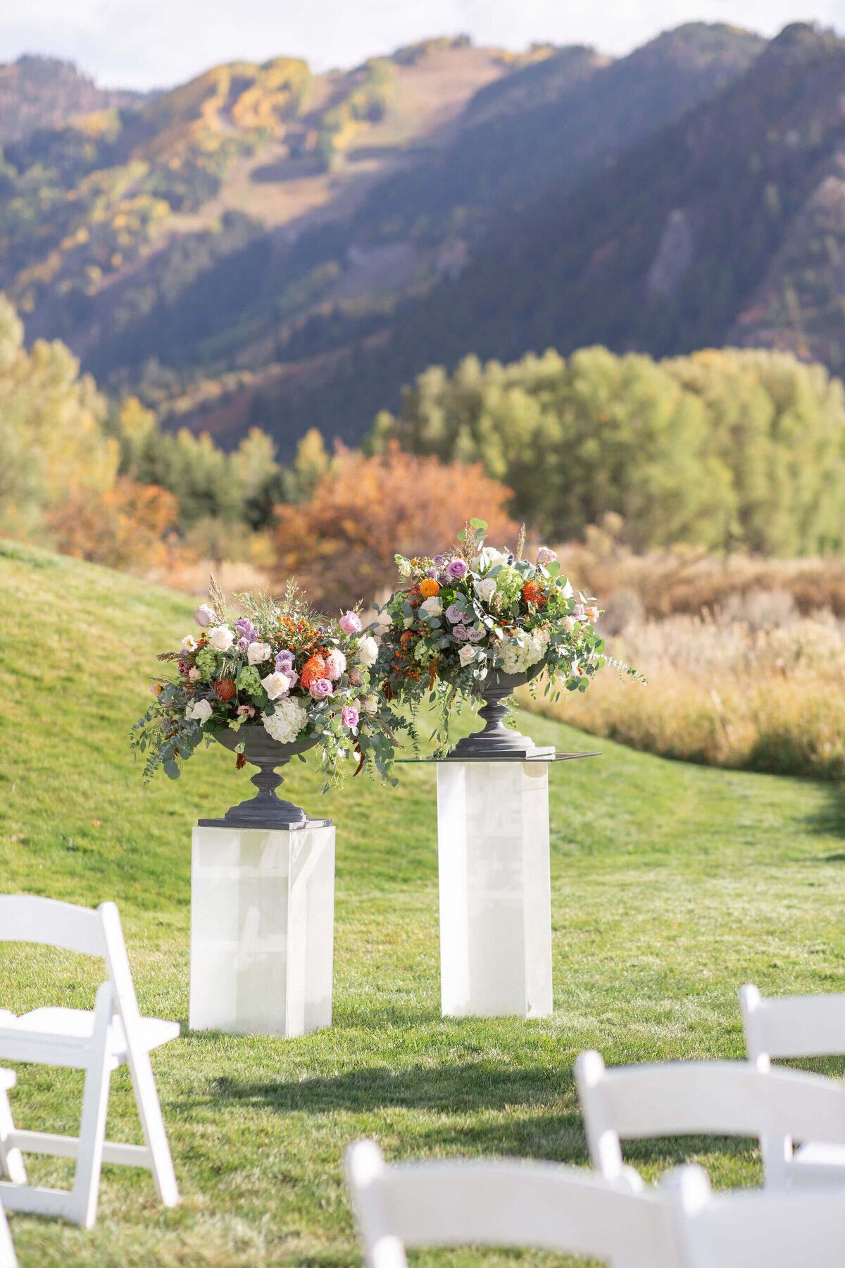 Ceremony flowers sit atop pillars