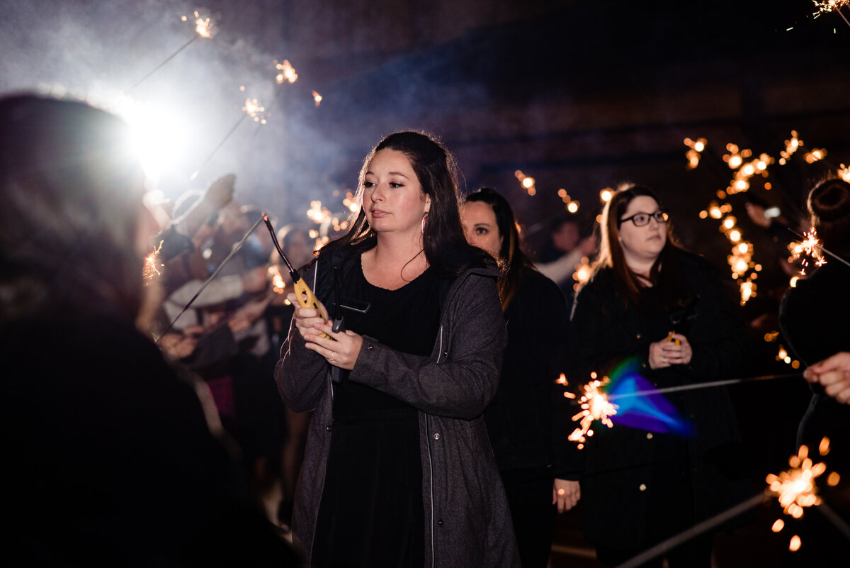 Wedding planner with Weddings & Events by Raina lights sparklers for the wedding send off