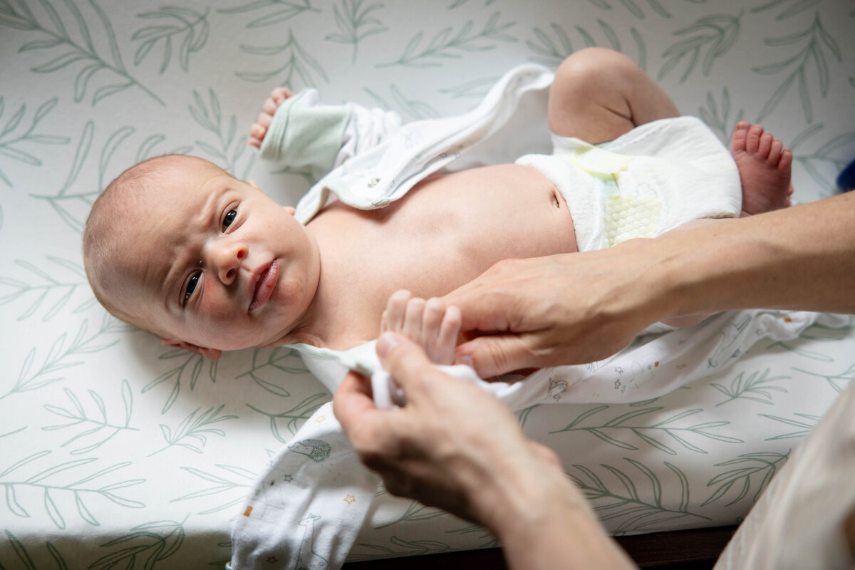 Newborn baby being changed on changing table