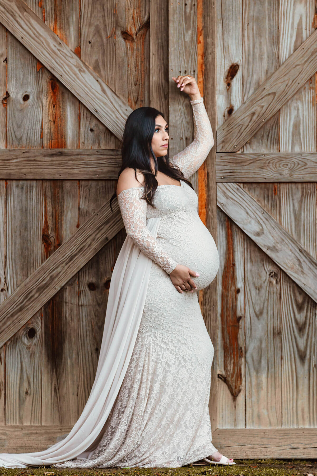 Maternity portrait in front of a barn captured by Danielle Dott Photography.