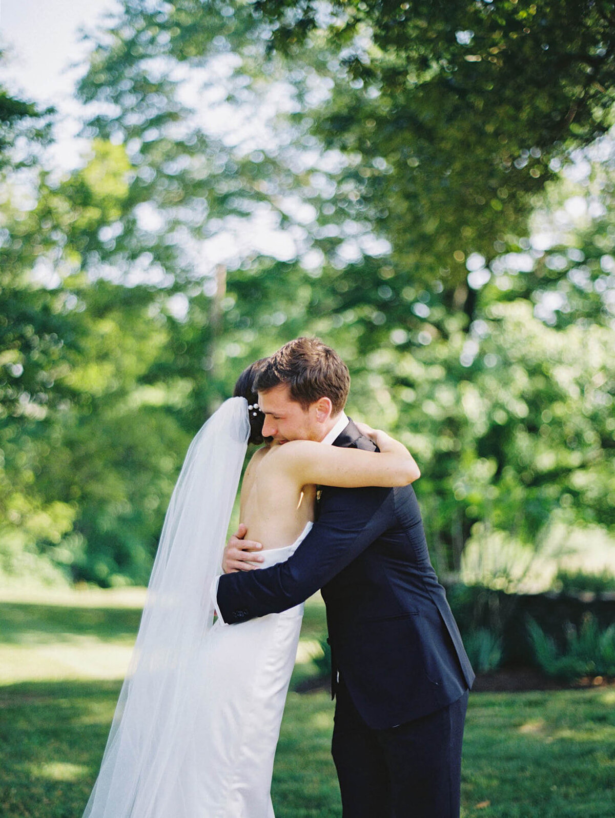 A bride and groom embrace for the first time on their wedding day