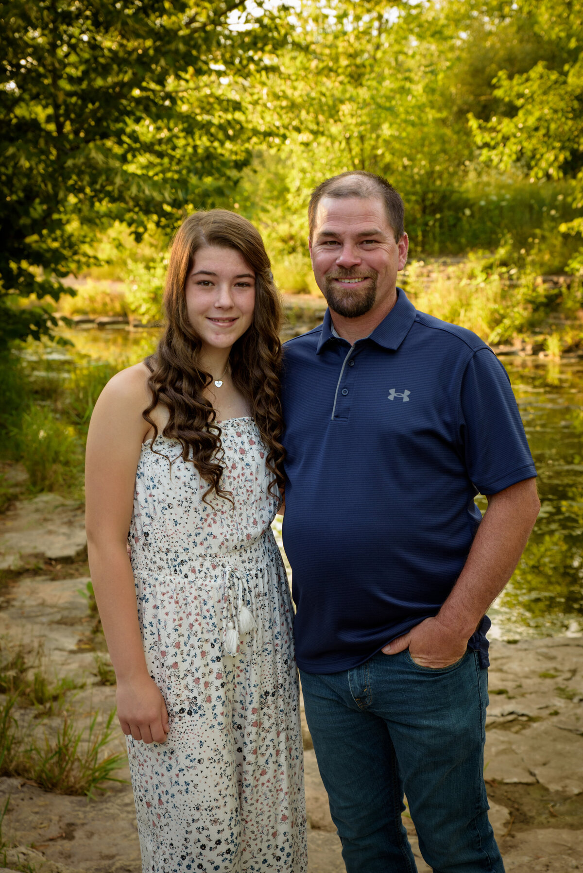 Father and daughter portrait standing with their arms around each other near the creek at Fonferek Glen County Park near Green Bay, Wisconsin