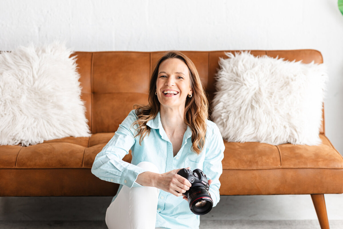 Chattanooga senior photographer holding her camera and smiling
