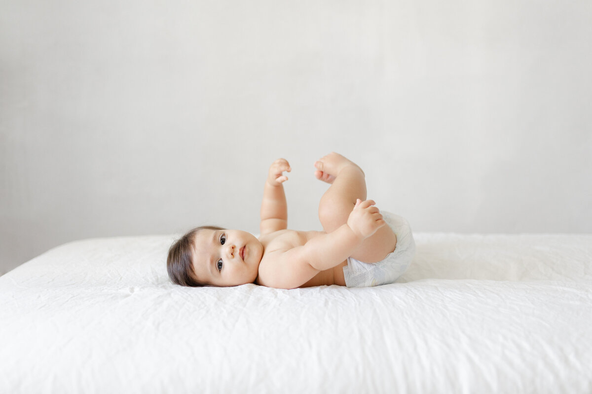 Tampa Milestone Portrait of six month baby captured in elegant studio setting with soft, natural lighting