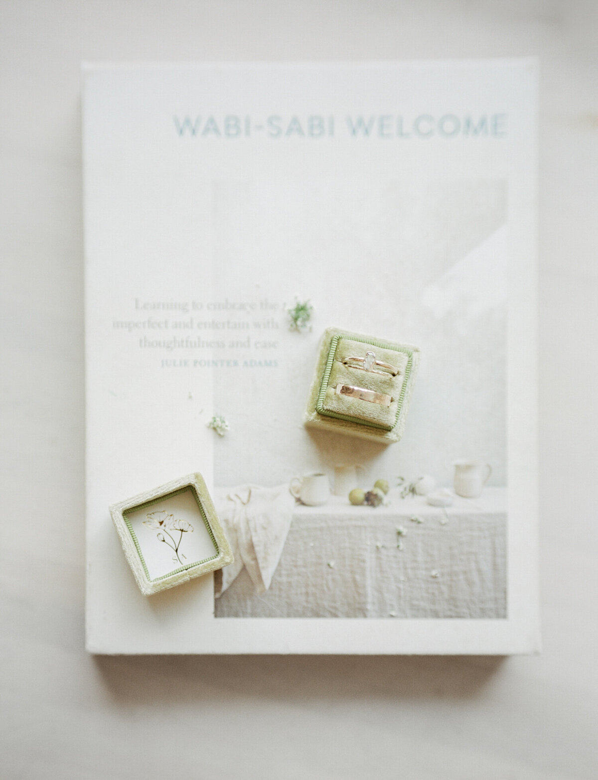 organic diamond engagement ring in ring box, wabi sabi welcome book, details at Glass House Community Michigan wedding venue
