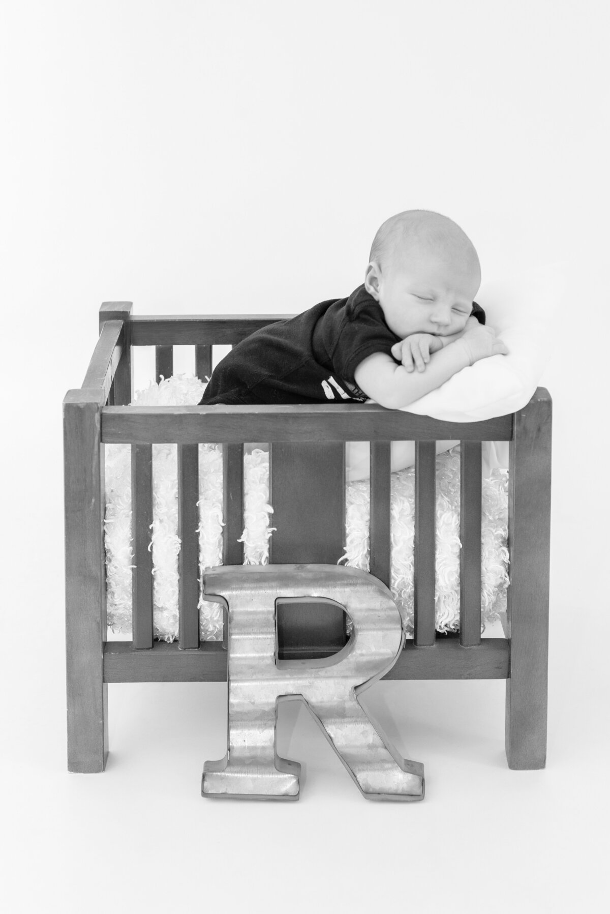 Portrait of baby boy sleeping in mini crib