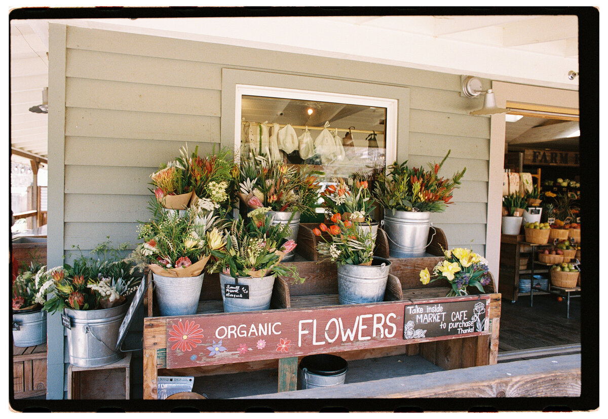 Flower shop captured on film by Kate Winters Photography, showcasing an authentic and candid moment in Carmel, California.