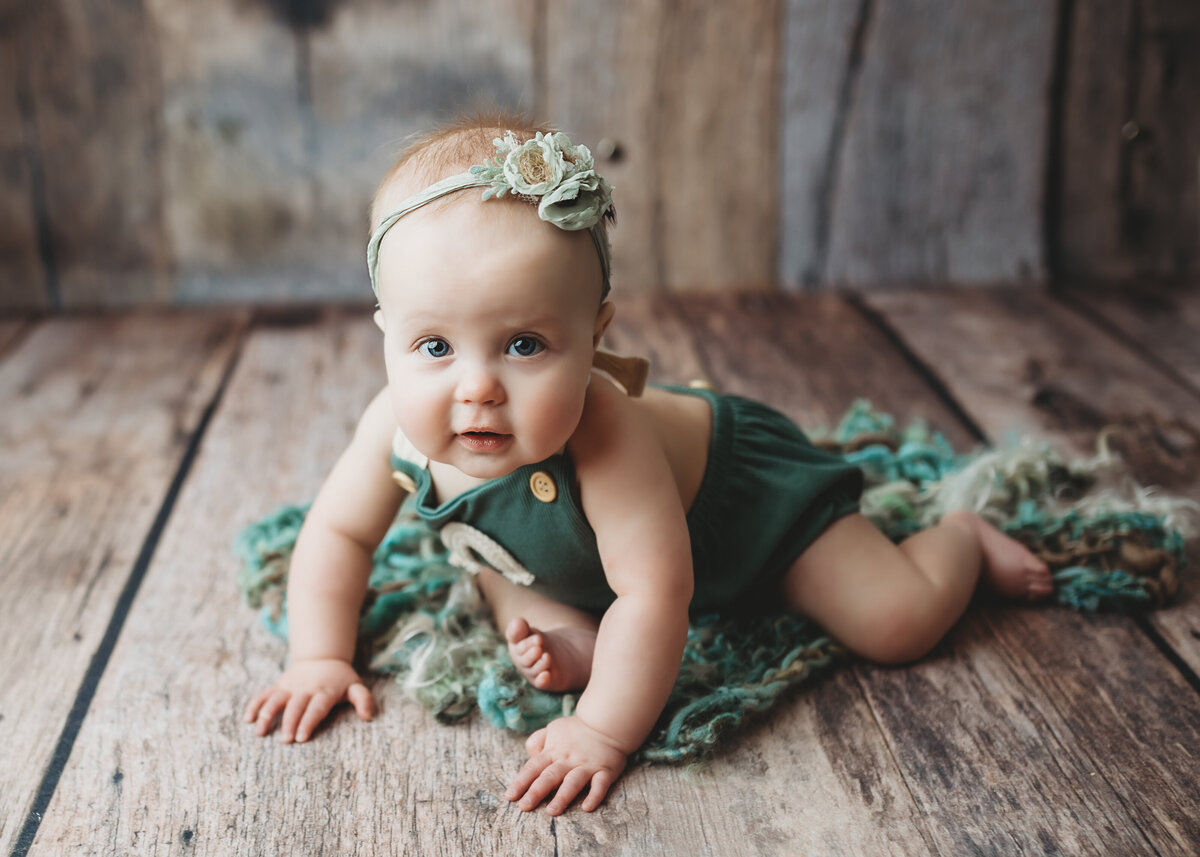baby girl crawls in Denver photography studio during sitter mileston photography session
