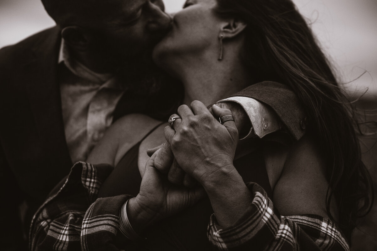 black and white close up of man and woman kissing
