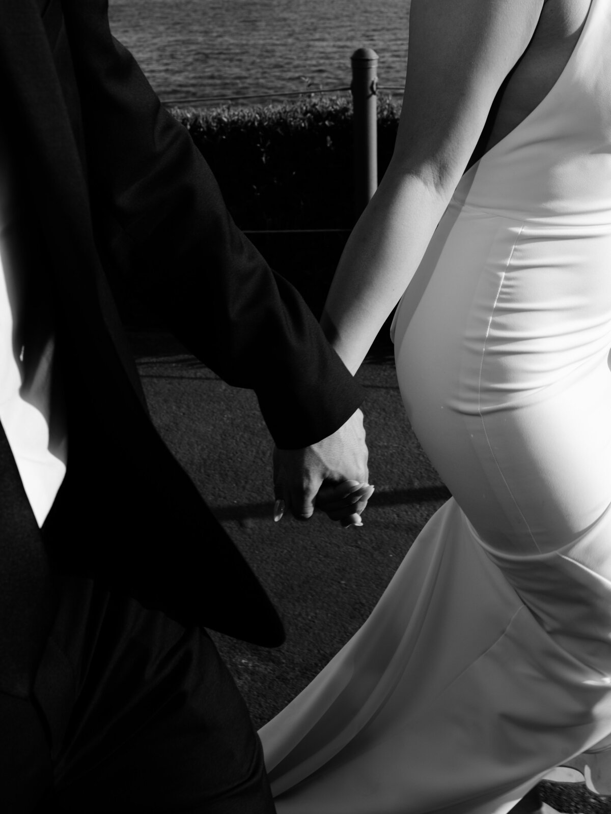 close up of bride and groom holding hands