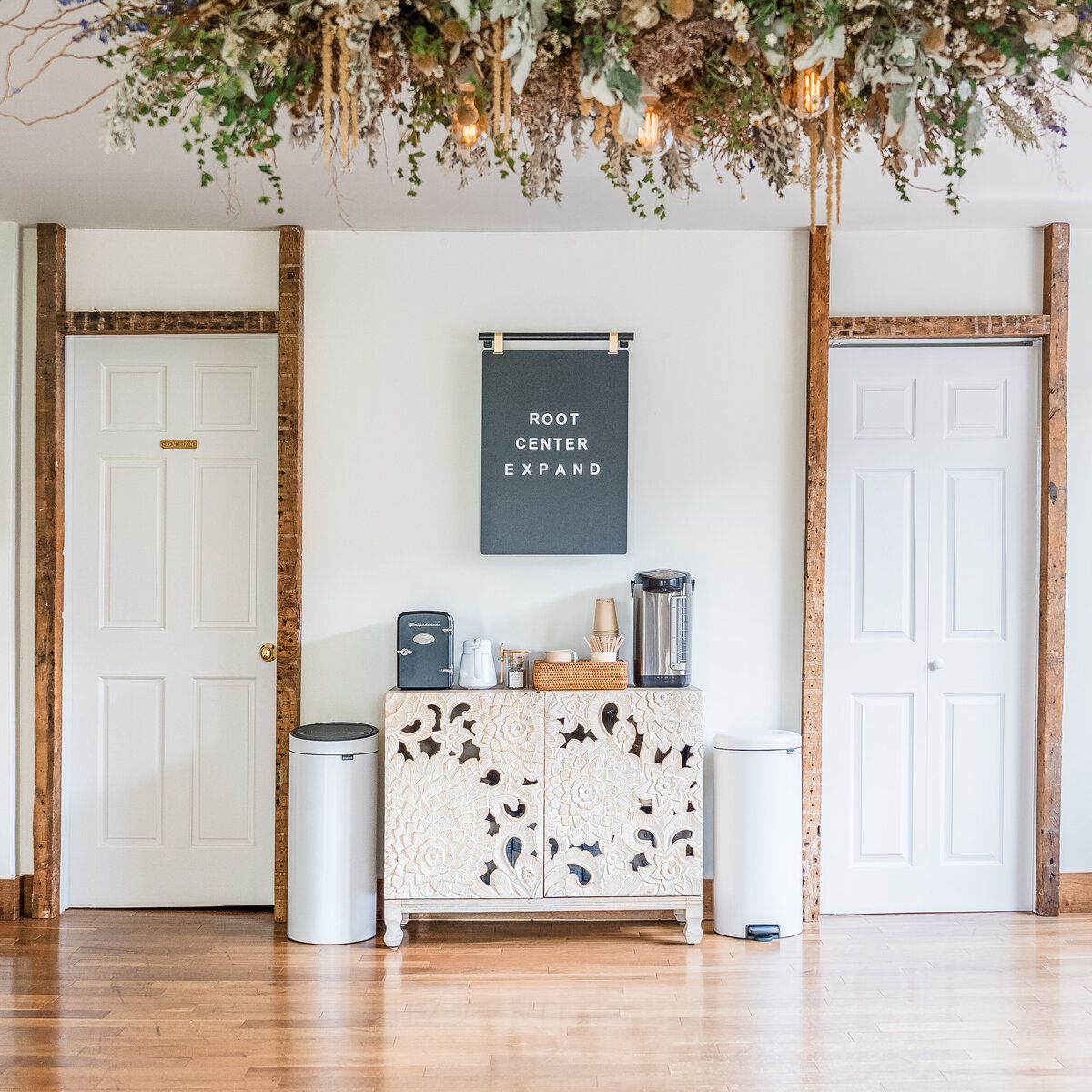 tea cabinet, black board and floral chandelier in empty meditation studio