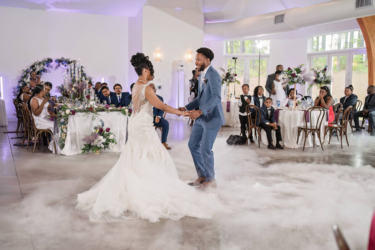 Romantic first dance with cloud effect, creating a fairytale wedding moment in Raleigh, NC.