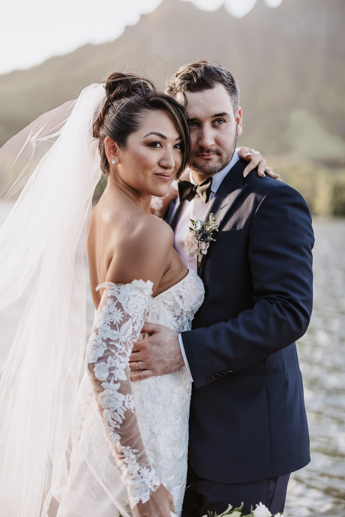Wedding couple candid portrait from the side in front of Koʻolau  mountain range