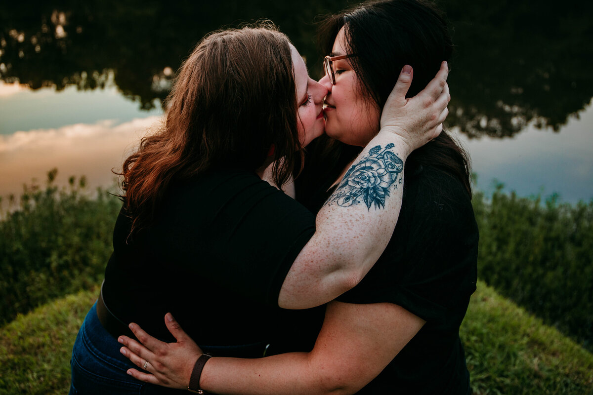 lesbian couple kissing at lake in birmingham alabama