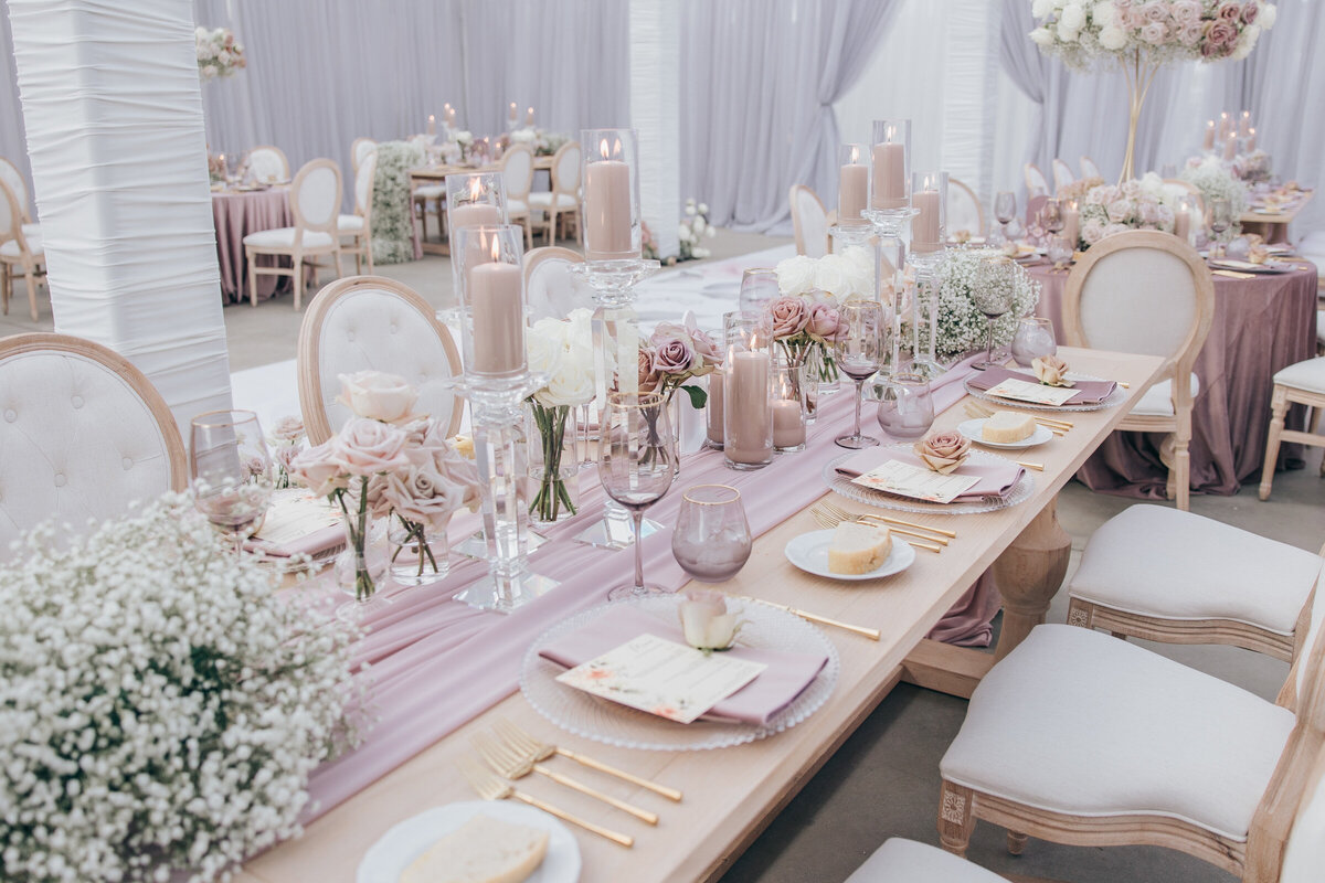 Chic wood and ivory head wedding table with lavender glassware and gold cutlery