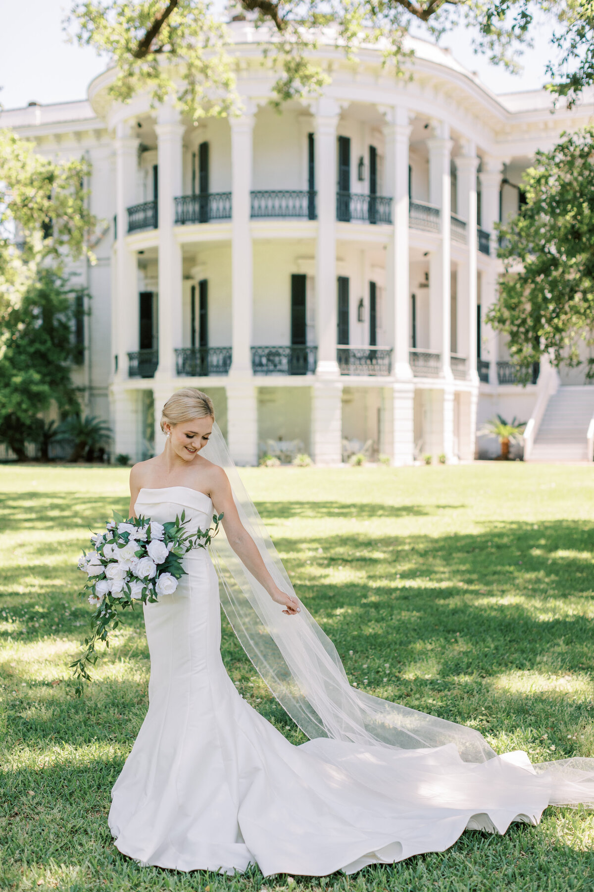 A bride stands in front of Nottoway Plantation.