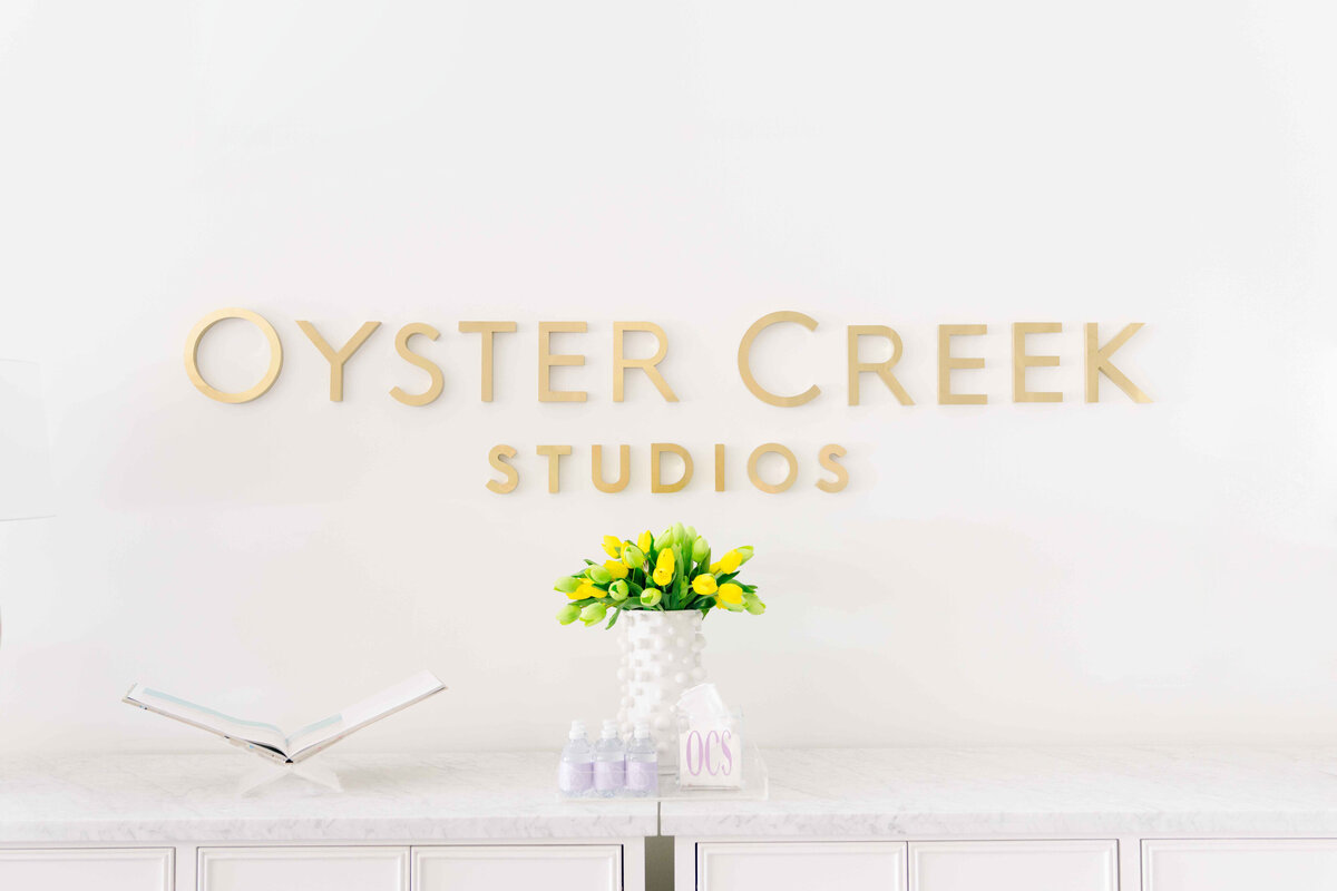 oyster creek studios office gold logo wall