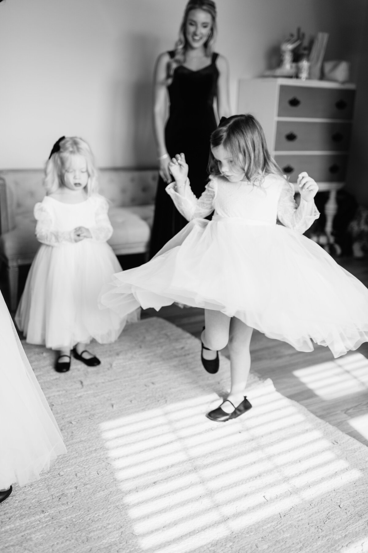 Flower girls dancing in black and white photo