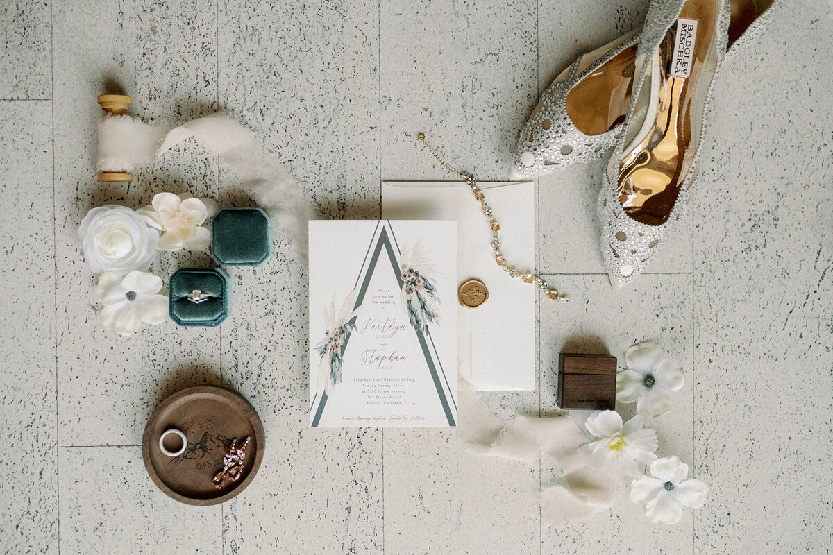 Wedding day details with emerald green, white, and gold details.