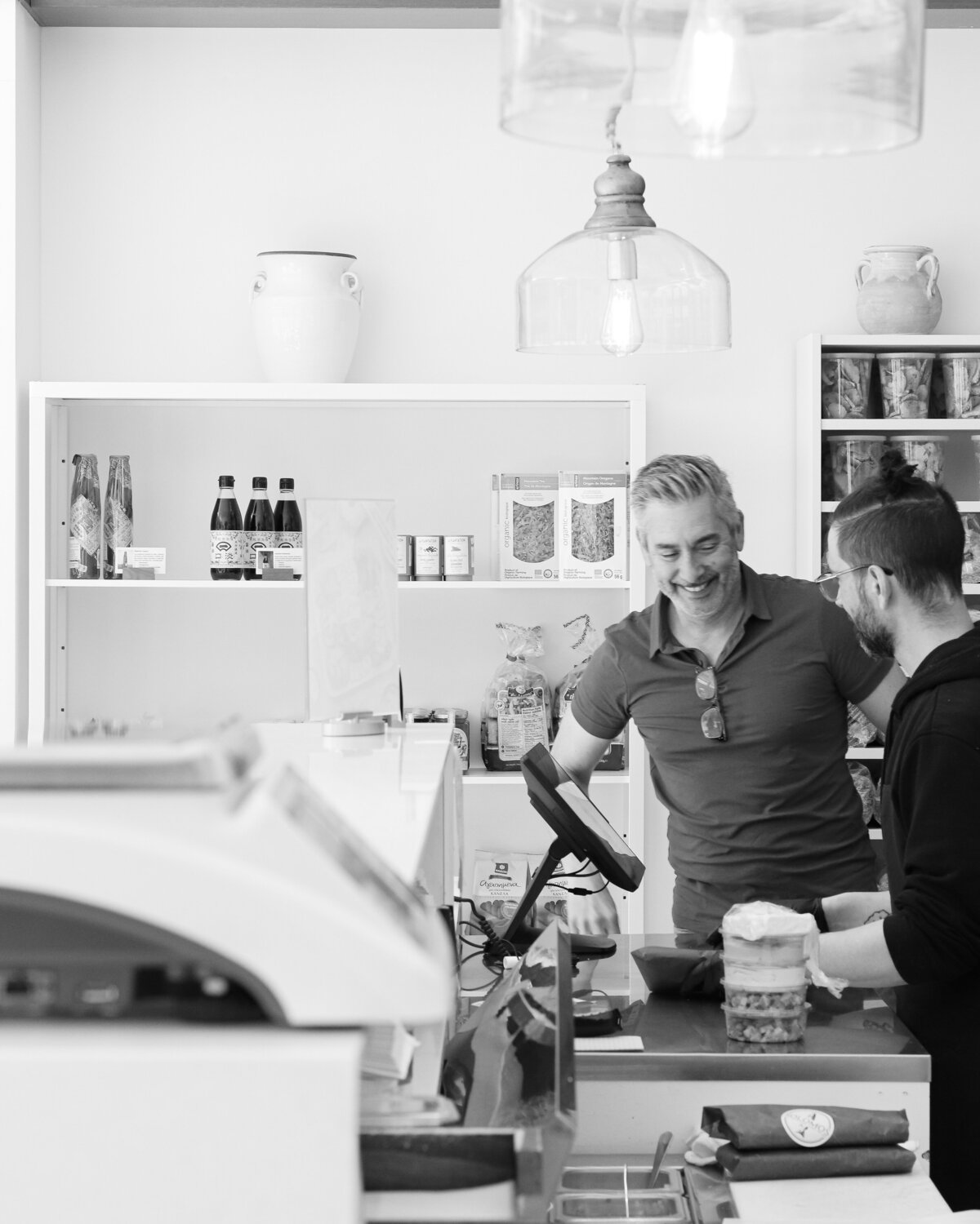 a man checking out a customer at a store counter