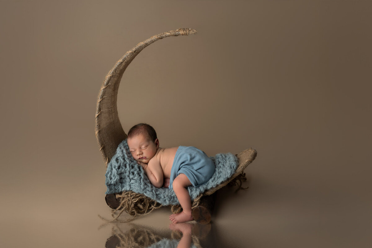 Newborn baby blue outfit moon prop Lago Vista professional photographer