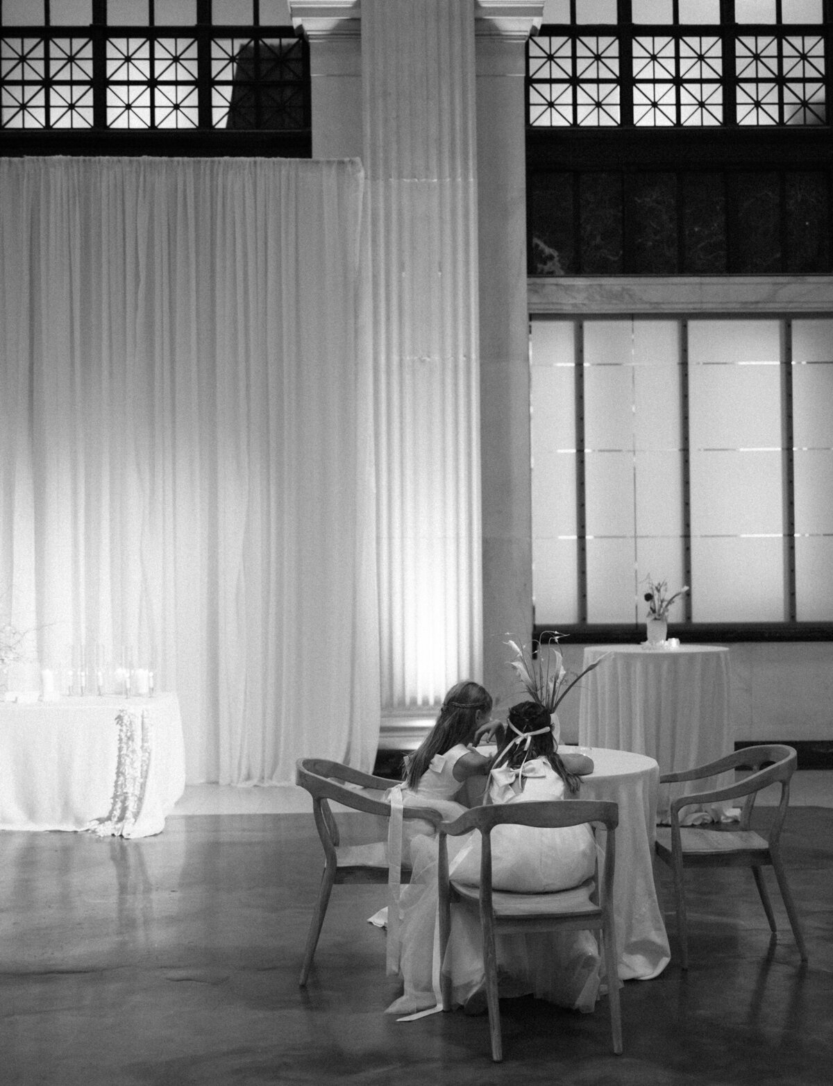 flower girls are caught playing on their phones at a Detroit wedding reception