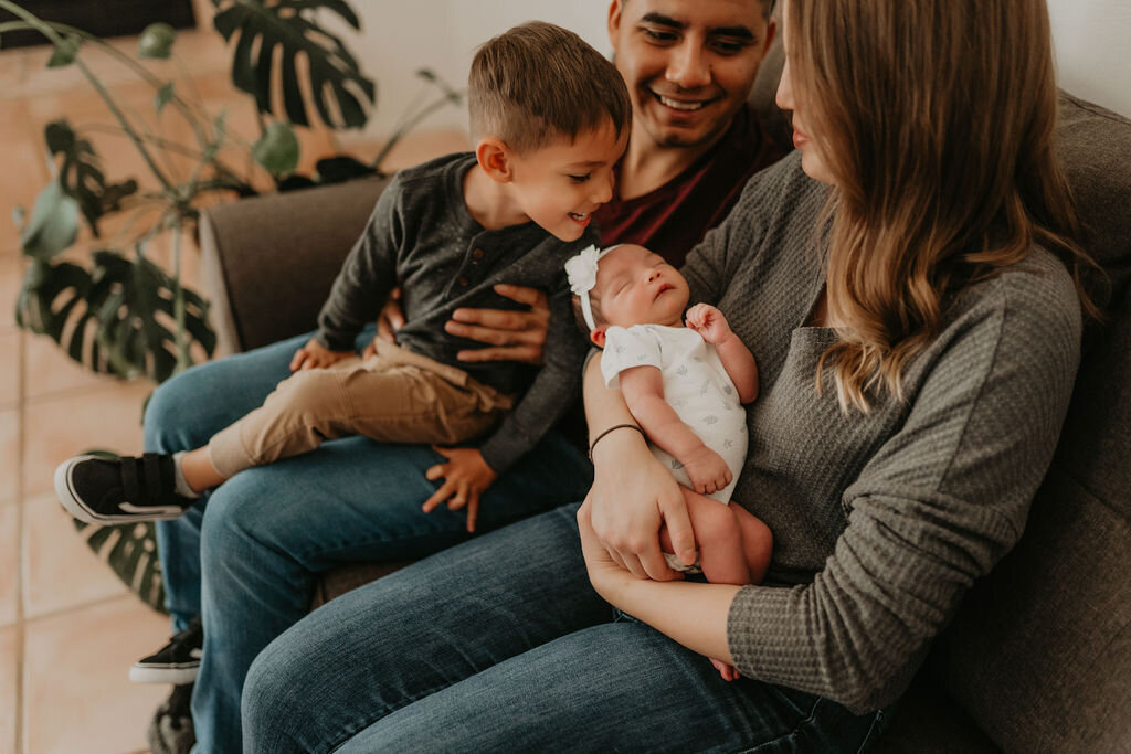 young tucson family toddler kissing new baby