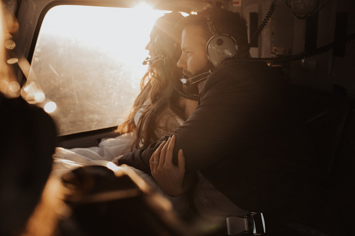 Bride and groom sharing a moment in a helicopter.