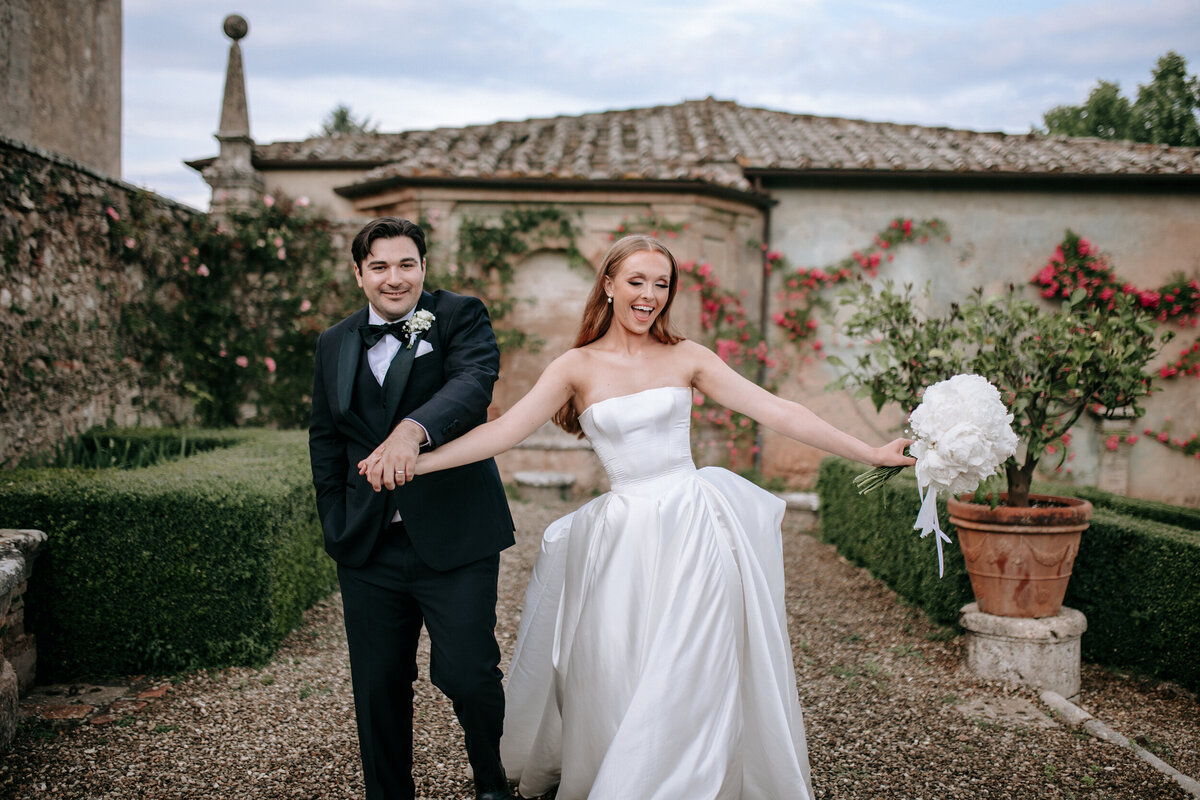 Bride and groom walking photo in Castello di Celsa wedding venue