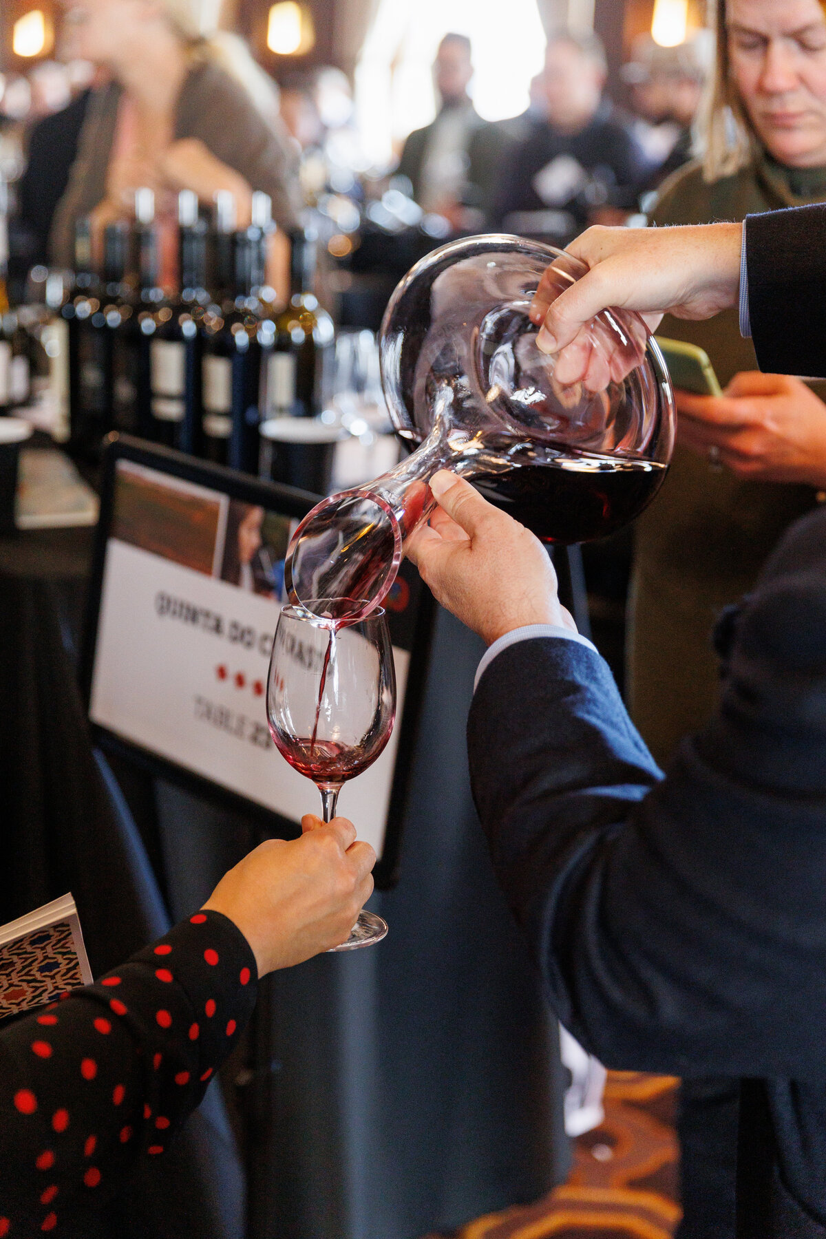 poring wine into a glass of wine