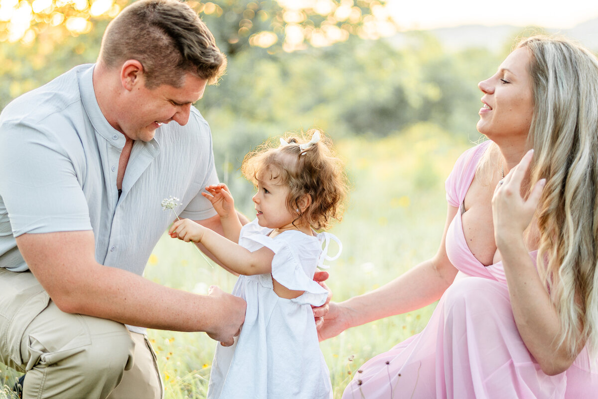 little girl giving dad a flower