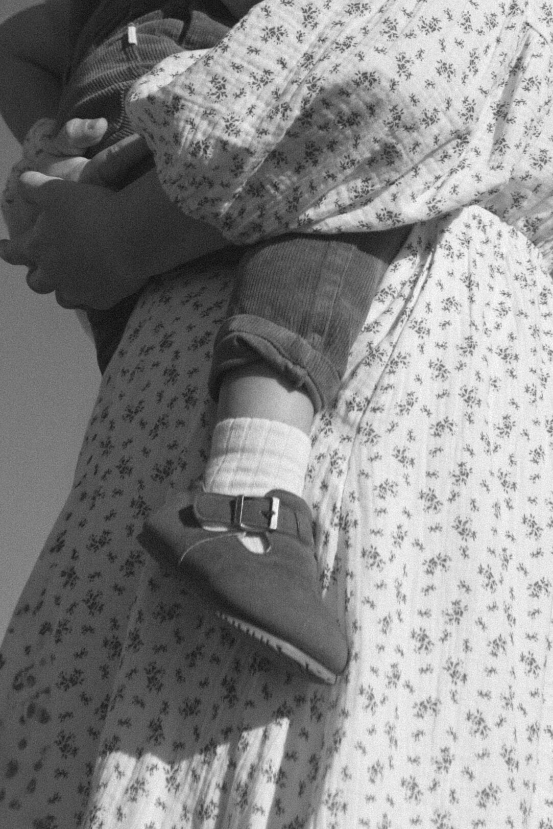 black and white photo of a detail photo of a mother holding her son.