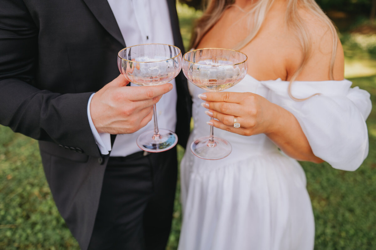 Two people clink glasses of champagne