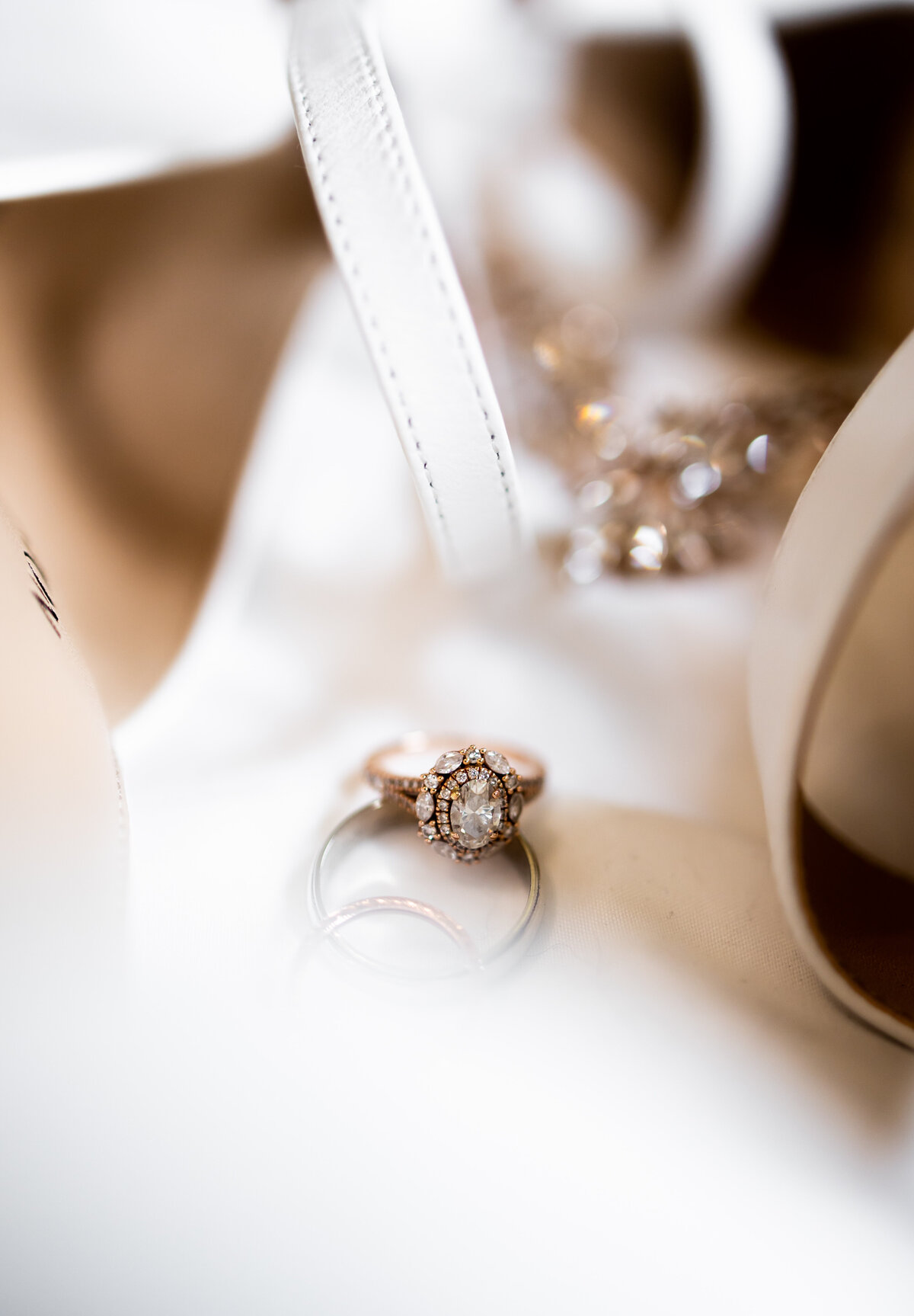 This stunning photograph features an engagement ring captured in a light and airy style, emphasizing the delicate craftsmanship and brilliant sparkle of the gemstone. Set against a soft, blurred background that enhances the ring's elegance, this image beautifully illustrates the romantic and sophisticated essence of engagement jewelry. Ideal for couples seeking inspiration for their engagement photoshoots or for jewelers showcasing exquisite ring designs.
