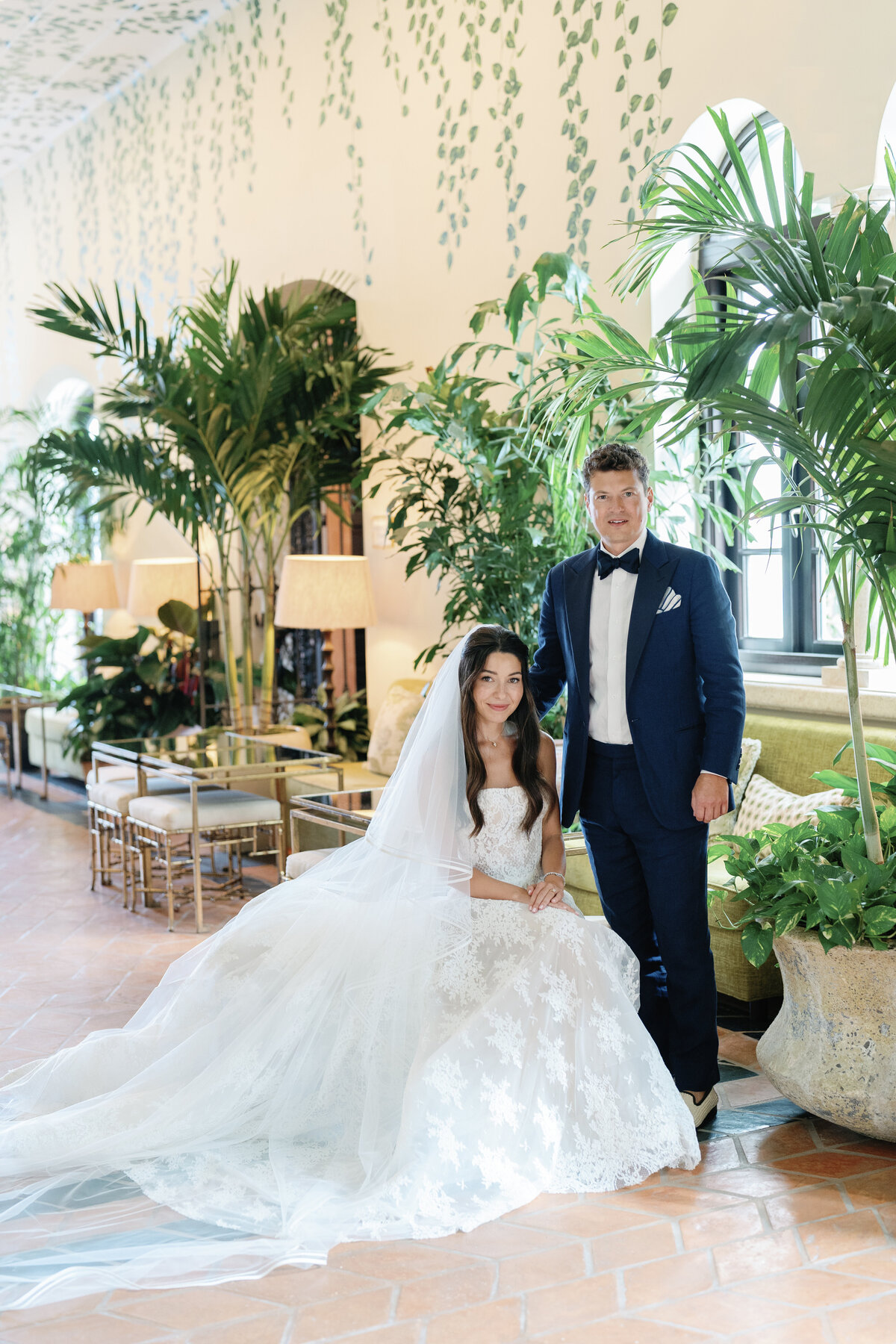 wedding portrait of a Miami couple in a plant-filled lobby