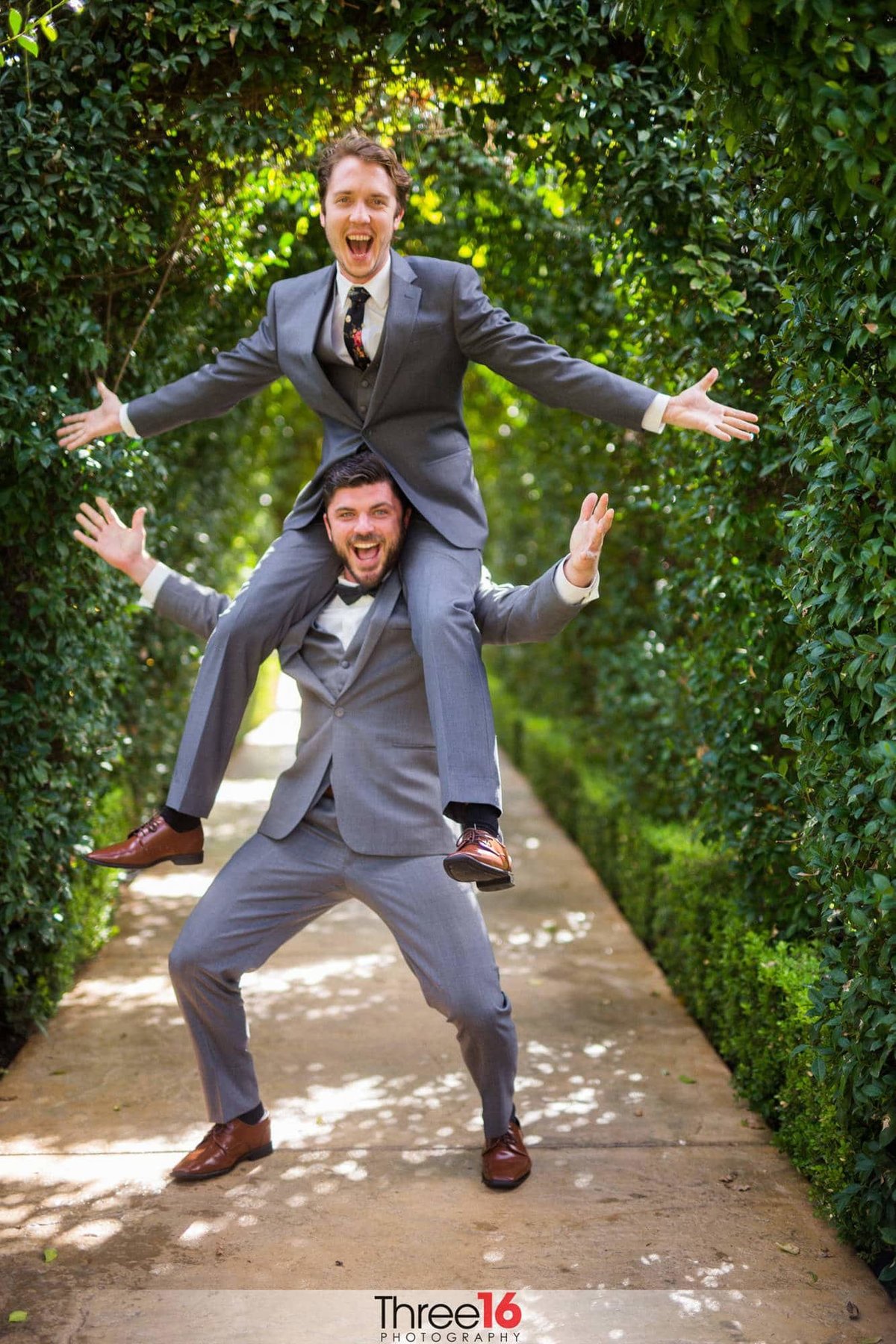Groom sitting on his Best Man's shoulders in a playful moment