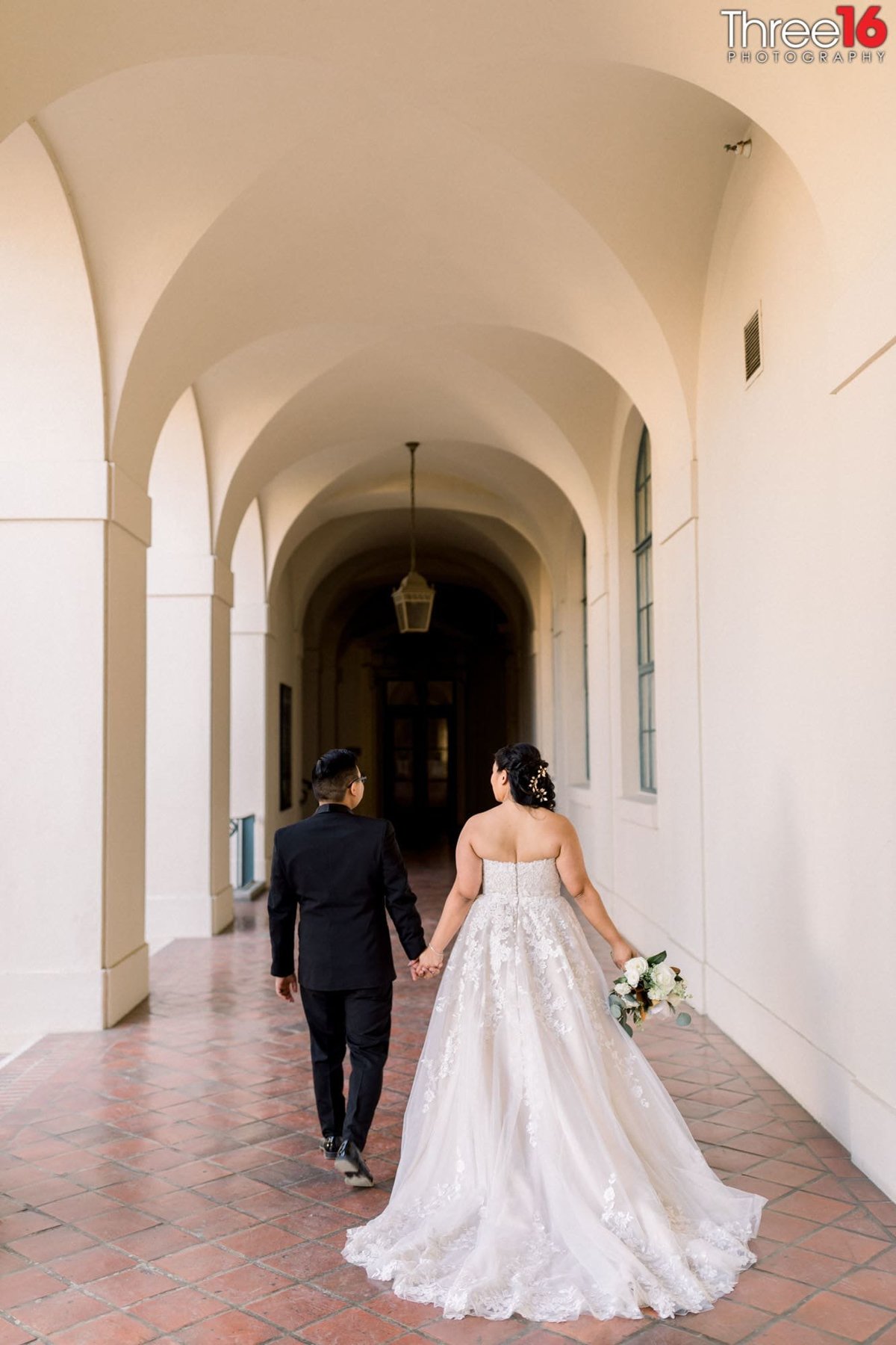 Bride and Groom walk away hand in hand at the Glen Arden Club in Glendale