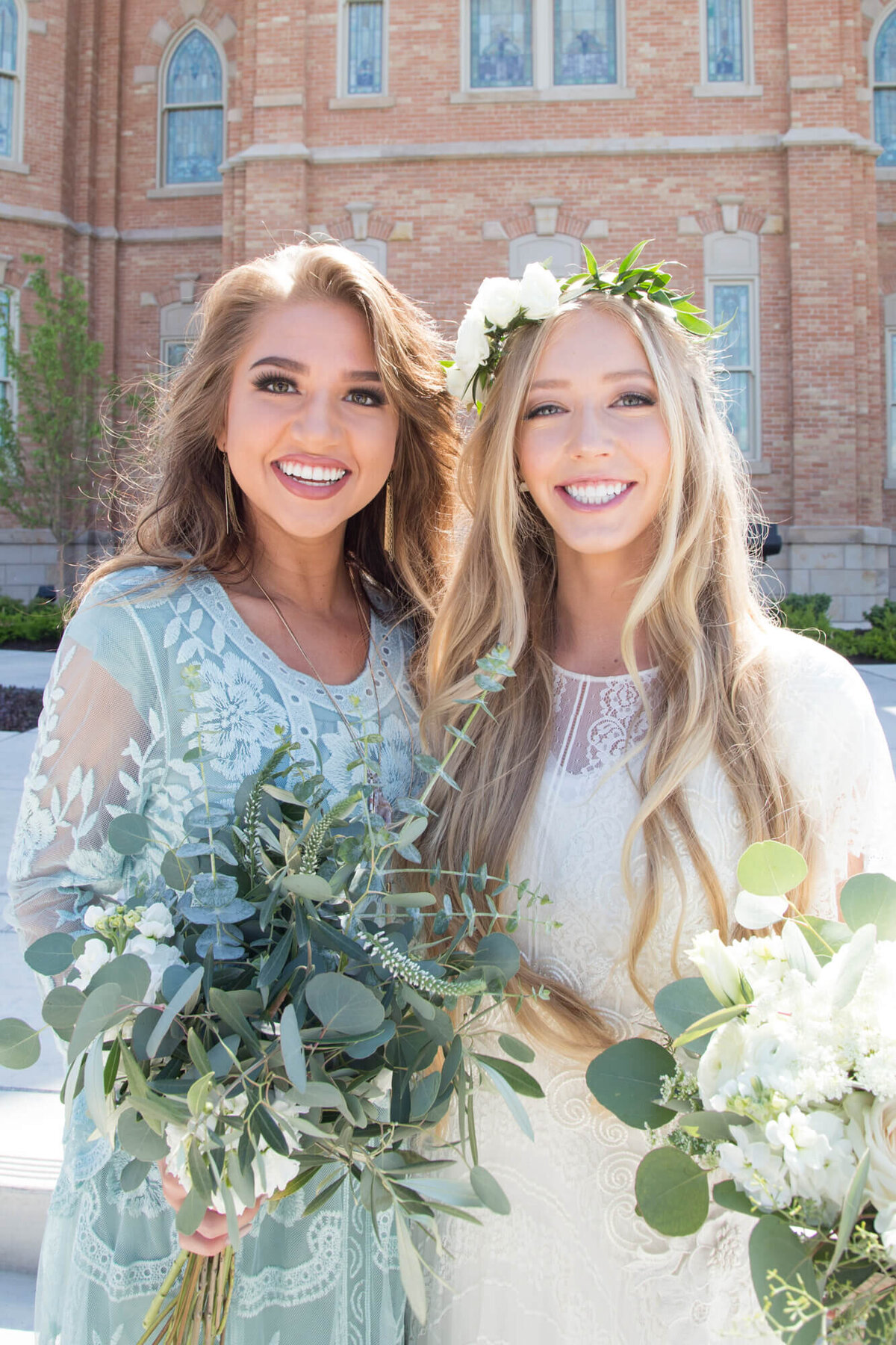 a bride and bridesmaid smiling