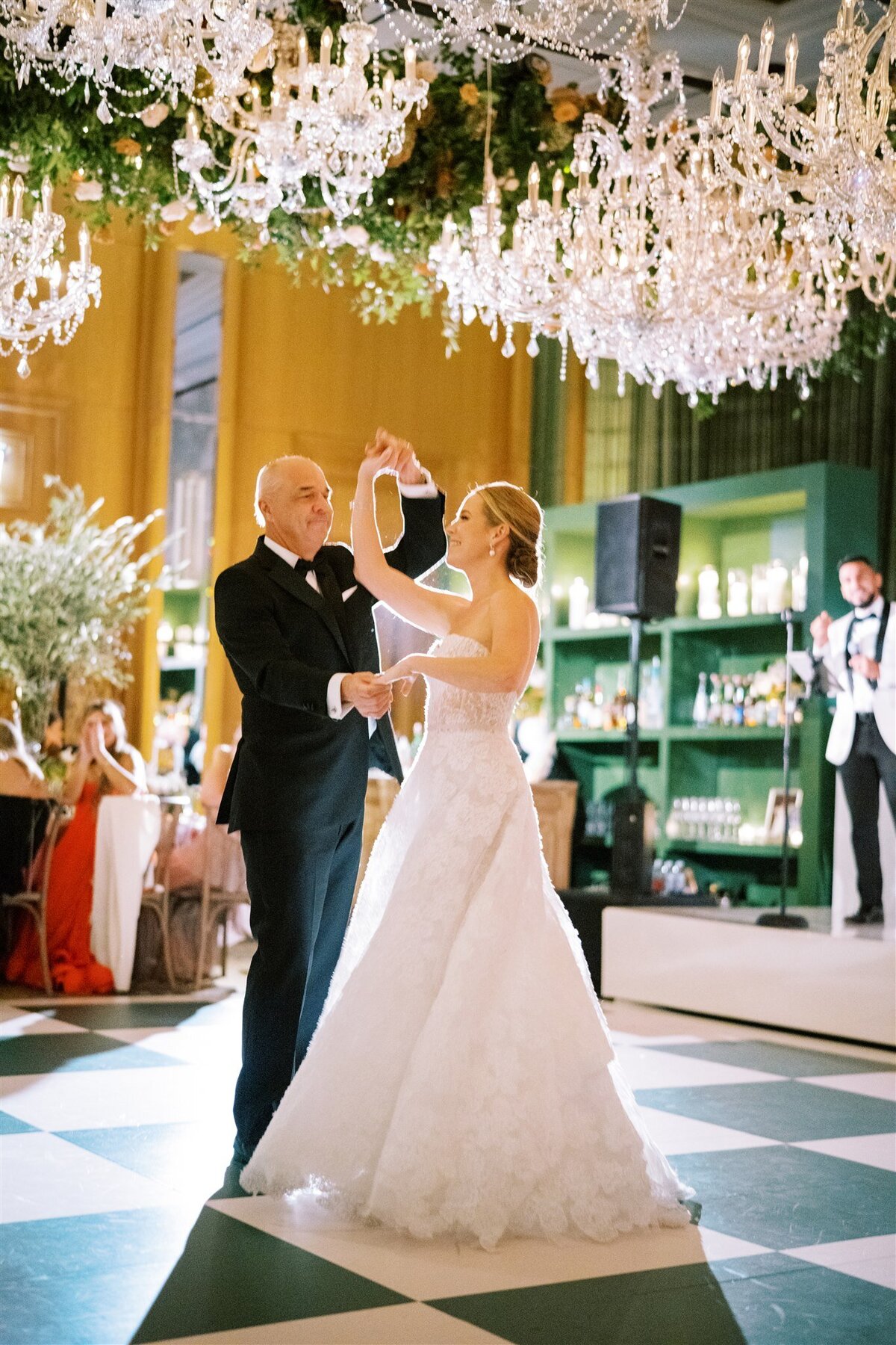 A picture of the bride being twirled by her father on the dance floor.